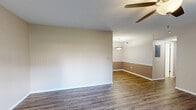 Located at 617 Richardson St in Simpsonville, SC, this single-floor, 2-bedroom, 2-bathroom home offers a practical and comfortable layout. The open living and dining area is finished with rich wood-look laminate flooring and features a ceiling fan overhead, while a pendant light anchors the dining space. Two-tone warm neutral walls add a subtle design touch throughout the common areas. The galley-style kitchen is well-equipped with warm wood cabinetry, white appliances including a coil-top range and refrigerator, a dishwasher, a stainless steel sink, and light countertops — all set atop tile flooring with ample upper and lower cabinet storage. Both bedrooms continue the wood-look flooring and are outfitted with ceiling fans for year-round comfort. The primary bedroom offers generous proportions and access to a closet, while the second bedroom features a window that brings in natural light. Each bathroom includes a full tub-shower combo, a vanity with wood cabinetry and light countertops, and tile flooring. A dedicated laundry area with washer/dryer hookups adds everyday convenience. Textured ceilings and consistent neutral tones throughout lend the home a cohesive, move-in-ready feel.