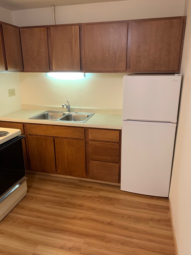 Kitchen in Unit w Laminate Flooring - Hilldale Towers