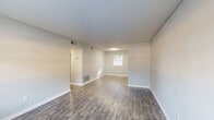Located at 180 S Pine Lake Dr in Spartanburg, SC, this single-floor, 4-bedroom, 1-bathroom home offers a practical and efficient layout. Wood-look plank flooring runs consistently throughout every room, complemented by neutral gray walls and crisp white trim, creating a clean and cohesive aesthetic.

The living room provides a welcoming entry point, with natural light filtering in through a window and a textured ceiling overhead. The kitchen is outfitted with light maple cabinetry, light-toned countertops, a stainless steel sink, and a white range, with a rear door offering additional access and natural light.

All four bedrooms share a consistent design language — neutral gray walls, wood-look flooring, white panel doors, and individual windows with blinds that allow natural light to brighten each space. The primary bedroom offers a notably generous footprint compared to the remaining bedrooms.

The single full bathroom features a tub/shower combination with a white surround, a toilet, a vanity with storage, and a window for ventilation and natural light. Wood-look flooring continues into this space, maintaining the home's uniform style.

A hallway connects the rooms efficiently within the compact floor plan. Throughout the home, the consistent finishes and neutral palette create a tidy, move-in-ready atmosphere suited for a variety of occupants.