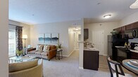 Located at 1108 Carriage Knoll Ln in Columbus, Ohio, this single-floor residence offers two bedrooms and two bathrooms within a thoughtfully laid-out floor plan. The entrance welcomes you with a console area that opens into a carpeted living room bathed in natural light from large French doors, which lead to an outdoor space and frame views of the surrounding greenery. The open ambiance of the living area is enhanced by neutral tones and generous wall space.

The galley-style kitchen features rich dark cabinetry, granite-style countertops, wood-look flooring, and a full suite of black appliances including a refrigerator, electric range, and built-in microwave. Ample upper and lower cabinet storage ensures excellent functionality.

The primary bedroom is a comfortable and serene retreat, featuring plush carpet, a window with natural light, and neutral walls. The second bedroom is similarly appointed, offering a cozy and well-proportioned space.

Both bathrooms are finished with dark wood vanities, granite-style countertops, and tile flooring. One bathroom includes a walk-in shower with glass doors, while the other features a shower-tub combination. A hallway connects all rooms, contributing to an efficient and practical flow throughout the residence.