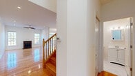 Located at 1216 Bradley Cir in Elgin, IL, this three-bedroom, five-bathroom home spans three thoughtfully laid-out floors. Gleaming hardwood floors flow throughout the main and upper levels, reflecting natural light that pours in through generous windows. The main floor features an open living room with a ceiling fan, a dining area adorned with a classic chandelier and sliding glass doors leading to an outdoor balcony, and a well-appointed kitchen equipped with warm wood cabinetry, granite countertops, and stainless steel appliances. A classic wood-railed staircase connects all three levels with timeless charm. The upper floor houses three bedrooms, including a spacious primary suite with a custom built-in closet system offering shelving, hanging rails, and integrated drawers. The five bathrooms are elegantly finished, with at least one featuring floor-to-ceiling marble tile surrounding a soaking tub and glass-enclosed shower. A dedicated laundry room with a full washer and dryer adds everyday convenience. The lower level offers a versatile, tile-floored space with recessed lighting and utility rooms, ideal for storage or additional use. This well-structured home delivers a balance of classic design and functional living.