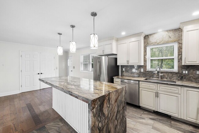 Large kitchen island with waterfall granite - 1319 Legend Rd
