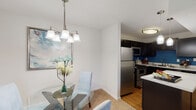 Located at 215 Codell Dr in Lexington, Kentucky, this single-floor unit offers a well-organized layout designed for comfortable everyday living. The kitchen is outfitted with dark cabinetry, stainless steel appliances including a refrigerator, range, and over-the-range microwave, light countertops, and hardwood-style flooring, accented by a bold blue feature wall that adds a pop of color to the space.

Adjacent to the kitchen, the dining area features neutral carpet, white walls, and a chandelier overhead, creating a clean and intimate setting for meals. The living room is carpeted and benefits from natural light through glass patio doors, and is equipped with a ceiling fan. A teal accent wall provides a focal point to the room.

The two bedrooms are carpeted and each includes windows that bring in natural light. Both rooms offer comfortable proportions suitable for standard bedroom furnishings. The unit includes two bathrooms: one with a walk-in shower and dark vanity cabinetry, and a second with a full tub/shower combination, both finished with tile flooring and clean, bright fixtures throughout.