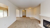 Located at 1325 E Foxhill Dr in Fresno, CA, this single-floor, 2-bedroom, 2-bathroom home offers a practical and comfortable layout with a cohesive, neutral design throughout. The open living area features plush wall-to-wall carpeting, a ceiling fan, and a pass-through window connecting to the kitchen, creating a sense of openness and easy flow. Sliding glass doors lead to an outdoor patio, bringing in natural light and providing convenient outdoor access. The kitchen is well-appointed with warm honey-toned wood cabinetry, light countertops, and a full suite of white appliances, including a refrigerator, range, microwave, and dishwasher. Track lighting overhead ensures a bright, functional workspace. Both bathrooms are finished with tile flooring, a tub-shower combination with sliding glass enclosures, and warm wood vanities. The primary bedroom is generously sized, featuring carpet flooring, a ceiling fan, and an arched window that fills the room with natural light. The second bedroom also offers carpeted floors and dual sliding closet doors, providing excellent storage. The home's consistent use of neutral tones and practical finishes creates a clean and welcoming atmosphere throughout.