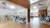 Located in Citrus Heights, CA, this fitness center at 7799 Farmgate Way offers a well-equipped, single-floor facility designed to support a comprehensive workout experience. The space is divided into a main exercise room and a connecting hallway, providing a logical and functional layout.

The exercise room is generously sized and thoughtfully organized into distinct cardio and strength training zones. The cardio area lines one side of the room and features multiple treadmills, elliptical trainers, and stair-climbing machines arranged in a row, oriented toward a bank of windows that invite natural light and outdoor views. The strength training zone houses an array of white-framed cable machines, weight benches, and resistance equipment, complemented by wall-mounted mirrors that enhance the sense of space and allow users to monitor their form.

Polished concrete floors in a warm golden-tan tone run throughout, providing a durable and easy-to-maintain surface. The vaulted and tray ceilings add vertical openness, while multiple ceiling fans ensure consistent air circulation. Flush and panel lighting fixtures provide bright, even illumination throughout.

The hallway connects the main exercise room to the entrance and features a vaulted ceiling, neutral walls with a two-tone finish, and an information board, offering a clean transitional space into the facility.