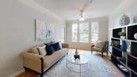 Located at 335 Bridgewater Drive in Savannah, Georgia, this single-floor residence offers a thoughtfully designed layout that balances functionality and comfort. The open-concept kitchen is a standout feature, equipped with rich dark-wood cabinetry, granite-style countertops, stainless steel appliances including a refrigerator, microwave, and range, and a peninsula with bar seating — ideal for casual dining or entertaining. Light wood-style flooring runs throughout the main living areas, complemented by crown molding that adds a refined touch.

The living room is bright and welcoming, with a ceiling fan, crown molding, and a bank of windows that frame views of the surrounding greenery, filling the space with natural light. Multiple bedrooms are carpeted for comfort, each offering generous proportions and windows that invite natural light. The primary bedroom connects to a private bathroom featuring tile flooring, a vanity with ample counter space, and a full-length mirror.

Additional bathrooms maintain a clean, neutral palette with tile floors and dark wood vanities. Throughout the residence, soft neutral tones create a calm, cohesive atmosphere well-suited to everyday living in Savannah.