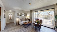 Located at 6250 N 19th Ave in Phoenix, Arizona, this thoughtfully designed one-bedroom, two-bathroom residence offers a comfortable and functional single-floor layout. Wood-style flooring flows throughout the space, complementing the neutral color palette and textured ceilings that add character to each room.

The living room is a welcoming centerpiece, filled with natural light from a large sliding glass door that opens to a private balcony with outdoor views of mature trees. The kitchen features warm honey-toned cabinetry, granite-look countertops, a double-basin stainless steel sink, and ample storage space. A dedicated office provides a quiet, versatile area with a window overlooking the outdoors, ideal for work or relaxation.

The primary bedroom offers generous proportions, a closet, and a bright window, creating a calm and restful retreat. Both bathrooms are equipped with safety-conscious features including grab bars, with one bathroom showcasing a tub/shower combination and wood-style flooring. Throughout the residence, accessibility-focused details reflect a practical and inclusive design sensibility. The overall ambiance is warm, functional, and inviting, making this Phoenix residence a comfortable and well-equipped home.