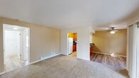 Located at 50 Washington St in Santa Clara, CA, this single-floor unit offers a practical and well-organized layout throughout its living spaces. The living area is spacious and carpeted, featuring baseboard heating and a sliding glass door that opens to a patio overlooking lush greenery and mature trees, filling the room with natural light. A ceiling fan and an additional window further enhance the bright, airy atmosphere.

The kitchen is thoughtfully designed with warm wood cabinetry, dark granite countertops, and a peninsula that provides extra prep and dining space. White appliances, including a refrigerator, stove, and microwave, are neatly integrated. Wood-style flooring runs through the kitchen and adjoining areas, creating a clean contrast with the carpeted rooms.

The bedrooms are well-sized and carpeted, each benefiting from natural light through large windows with outdoor views. The primary bedroom features generous built-in closet space with open shelving and hanging rods. Additional rooms offer neutral walls and baseboard heating.

The bathroom includes dark granite countertops consistent with the kitchen's finishes, a vessel-style sink, and a full tub-shower combination with sliding glass doors and a privacy window above.