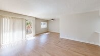 Located at 6060 Buckingham Pkwy in Culver City, California, this single-floor unit offers a clean, updated interior with a neutral color palette throughout. The living area is generously sized, featuring light hardwood-style flooring that extends across the open layout. Large sliding glass doors flood the space with natural light and provide access to a balcony with greenery views, while a ceiling fan adds comfort overhead. The textured ceiling is consistent throughout the main living spaces, lending a classic residential character.

The kitchen has been thoughtfully updated with white shaker-style cabinetry, brushed nickel hardware, white quartz countertops, a deep single-basin sink, and a classic subway tile backsplash. Stainless steel appliances, including a refrigerator and dishwasher, complete the functional and attractive kitchen space.

The bedrooms are carpeted in a light, neutral tone and are well-lit by windows fitted with vertical blinds. Each bedroom offers a calm, comfortable atmosphere with ample wall space. The bathroom is finished with a white dual-sink vanity topped with quartz, a large mirror, a full soaking tub with shower, and light tile flooring, presenting a bright and clean aesthetic. This well-maintained unit combines practical updates with a comfortable, move-in ready layout in a desirable Culver City location.