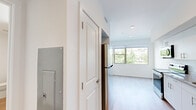 Located at 327 E Fountain Blvd in Colorado Springs, CO, this efficiently designed single-floor unit offers a bright and contemporary living environment. The open-concept layout seamlessly connects the kitchen and living area, creating a functional and airy feel despite its compact footprint. Light wood-look flooring flows throughout the main living spaces, contributing to a clean, modern aesthetic.

The kitchen is well-equipped with stainless steel appliances, including a refrigerator, electric range, built-in microwave, and dishwasher. White cabinetry extends to the ceiling, maximizing storage, while a granite-style countertop adds a refined touch. A window above the sink and a larger window in the living area flood the space with natural light and offer pleasant views of the surrounding greenery.

The bedroom features soft carpet flooring and is served by two closets, providing generous storage. A large window frames views of the tree-lined neighborhood, enhancing the room's bright and calm atmosphere.

The bathroom is clean and modern, featuring wood-look flooring, a white vanity with a stone-topped countertop, and a separate water closet. Recessed lighting and neutral white walls throughout the unit contribute to an overall sense of openness and simplicity, making this a practical and polished urban residence.