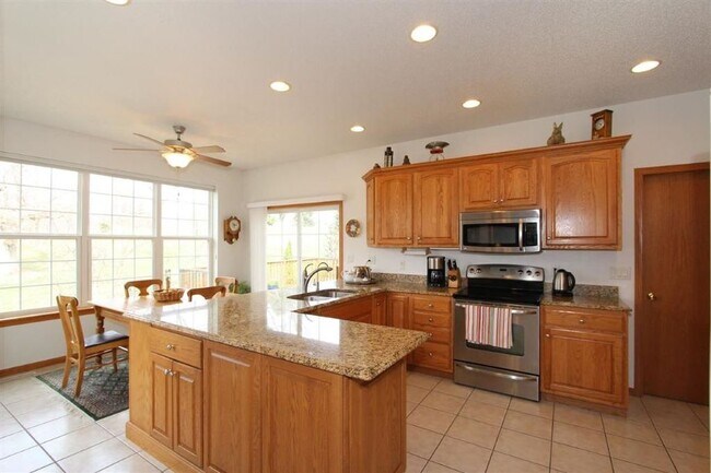 Sunny modern kitchen with granite counters. - 765 Breconshire Ln