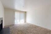 Located in Dallas, TX, this single-story, one-bedroom, one-bathroom residence offers a well-organized layout across a comfortable and functional floor plan. The living room serves as the heart of the home, highlighted by a classic tile-surround wood-burning fireplace and a large sliding glass door fitted with vertical blinds that fill the space with natural light. Plush carpeting extends throughout the main living areas, adding warmth underfoot.

The kitchen is efficiently designed with dark wood cabinetry, white appliances including a range and refrigerator, a light-toned countertop, and a peninsula breakfast bar that opens to the dining area — ideal for casual meals. Wood-look flooring in the kitchen and entryway provides a durable, easy-to-clean surface. A dedicated laundry area adds everyday convenience.

The spacious bedroom features soft carpet, a ceiling fan with light fixture, a natural light window, and direct access to a generously sized walk-in closet. The full bathroom is appointed with a tiled tub-shower combo, wood-look flooring, and a dark-vanity with a marble-style countertop. Four closets throughout the unit ensure ample storage. The space also includes a hallway connecting all rooms cohesively.