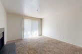 Located in Dallas, TX, this single-story, one-bedroom, one-bathroom residence offers a well-organized layout across a comfortable and functional floor plan. The living room serves as the heart of the home, highlighted by a classic tile-surround wood-burning fireplace and a large sliding glass door fitted with vertical blinds that fill the space with natural light. Plush carpeting extends throughout the main living areas, adding warmth underfoot.

The kitchen is efficiently designed with dark wood cabinetry, white appliances including a range and refrigerator, a light-toned countertop, and a peninsula breakfast bar that opens to the dining area — ideal for casual meals. Wood-look flooring in the kitchen and entryway provides a durable, easy-to-clean surface. A dedicated laundry area adds everyday convenience.

The spacious bedroom features soft carpet, a ceiling fan with light fixture, a natural light window, and direct access to a generously sized walk-in closet. The full bathroom is appointed with a tiled tub-shower combo, wood-look flooring, and a dark-vanity with a marble-style countertop. Four closets throughout the unit ensure ample storage. The space also includes a hallway connecting all rooms cohesively.