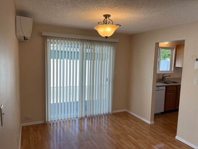 Dining area open to living room, slider door to private patio - 3801 56th Street Ct E