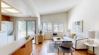 Located at 5016 Paseo Padre Parkway in Fremont, CA, this single-story, three-bedroom, one-bathroom home offers a practical and well-appointed layout across a compact but efficiently designed floor plan. Warm hardwood flooring runs throughout the main living areas and bedrooms, creating a cohesive and inviting atmosphere. The living room is a standout feature, boasting soaring vaulted ceilings that amplify the sense of space, large windows that invite abundant natural light, and a bright, open feel complemented by neutral wall tones. An adjacent dining area connects seamlessly to the living space, enhancing the open-plan flow. The kitchen is equipped with warm wood cabinetry, white appliances including a range, microwave, dishwasher, and refrigerator, plus a window above the sink. Notably, a stacked washer and dryer unit is integrated into the kitchen area for added convenience. The spacious primary bedroom features multiple windows with outdoor views, hardwood floors, and a textured ceiling. Additional bedrooms are well-sized with similar finishes. The bathroom includes a wood vanity, full mirror, and a tub-shower combination with tile flooring. A hallway and closet round out this efficiently organized home.