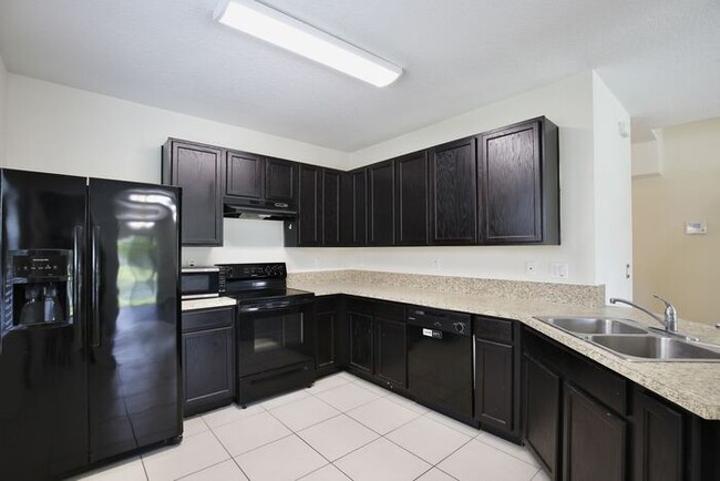 Building Photo - Spacious 3/2.5 Townhome with a 2 Car Garage and a Beautiful Pond View in Westwood Condos - Orlando!
