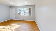 Located at 3051 Colonial Way in San Jose, CA, this 2-bedroom, 1-bathroom residence offers a thoughtfully designed single-floor layout. Warm hardwood-style flooring flows throughout the living spaces, complemented by soft, neutral blue-gray walls that create a calm and cohesive atmosphere.

The galley-style kitchen is well-appointed with crisp white cabinetry, granite countertops, a stainless steel sink, and a white electric range with overhead ventilation. A sliding glass door opens directly to a private balcony, allowing natural light to pour in and providing pleasant outdoor views.

Both bedrooms feature the same warm flooring and soft wall tones, with windows that bring in natural light. The primary bedroom offers a comfortable footprint, while the second bedroom provides a functional secondary space. A dedicated closet adds practical storage to the unit.

The bathroom is finished with large-format gray tile flooring, marble-style tile surround in the tub and shower area with a sliding glass enclosure, and white cabinetry beneath the vanity. A small window provides natural ventilation.

A hallway connects the main rooms, contributing to an efficient and well-organized floor plan. Overall, this residence presents a clean, updated aesthetic well-suited for comfortable everyday living in the heart of San Jose.