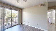 Located at 12521 Tinsley Cir in Tampa, FL, this single-floor, 3-bedroom, 2-bathroom residence offers a practical and well-organized layout. The living room features wood-style laminate flooring, a textured ceiling, and ceiling fan, with a sliding glass door opening to a private balcony that overlooks lush greenery — bringing natural light and outdoor views into the space.

The galley-style kitchen is efficiently designed with white cabinetry, light quartz-style countertops, a stainless steel sink, and wood-look flooring. It includes a refrigerator and black electric range, with ample upper and lower cabinet storage along both walls.

The three bedrooms feature neutral beige carpet and warm-toned walls. The primary bedroom includes balcony access via a sliding door, while the secondary bedrooms offer large windows with natural light and ceiling fans. All bedrooms maintain a clean, understated aesthetic.

Both bathrooms are finished in crisp white with tub-shower combinations, wood-look flooring, and white vanities. Two hallways connect the rooms efficiently throughout the layout, contributing to smooth circulation. Overall, the space presents a clean, neutral palette suited for comfortable everyday living.