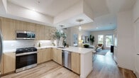 Located at 800 N Front St in Burbank, California, this thoughtfully designed three-bedroom, two-bathroom residence offers a bright and contemporary living experience. The open-concept layout seamlessly connects the kitchen, dining, and living areas, creating a welcoming flow throughout the home. Light wood-look flooring runs underfoot, complementing the clean, neutral palette found throughout.

The kitchen is a standout feature, outfitted with flat-front light wood cabinetry, white quartz countertops, a subway tile backsplash, stainless steel appliances, and a peninsula with pendant lighting — ideal for both cooking and casual dining.

The living room is airy and well-lit, with access to a private balcony and views of lush greenery outside. The spacious primary bedroom includes a dedicated walk-in closet with built-in shelving and hanging rods. Additional bedrooms are generously sized with large windows that invite natural light.

Both bathrooms are finished with large-format tile flooring. One features a soaking tub with shower, built-in shelving, and matte black fixtures. The second offers a wood-toned vanity with a wide mirror and modern lighting. The residence also includes a dedicated laundry area and three closets throughout, rounding out a complete and functional home.