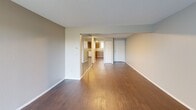 Located at 2703 S Topeka in Wichita, KS, this 2-bedroom, 1-bathroom unit offers a practical and well-organized single-floor layout. The living room is a generous, open space featuring rich, dark hardwood-style flooring and a textured ceiling, providing a welcoming area for everyday living and entertaining. It connects seamlessly to the kitchen, which is equipped with warm oak cabinetry, light countertops, a white electric range, and a full-size refrigerator — offering ample storage and functionality for meal preparation. Both bedrooms feature plush carpeting, neutral-toned walls, and textured ceilings. The primary bedroom includes a closet and provides a comfortable, private retreat. The second bedroom also includes a closet and offers flexible use as a guest room or home office. The full bathroom is appointed with an oak vanity, a large mirror, hardwood-style flooring, and grab bars for added accessibility. Throughout the unit, neutral wall colors and consistent finishes create a cohesive and clean aesthetic. The textured ceilings are a consistent architectural detail found across all rooms, contributing to the overall character of the space.
