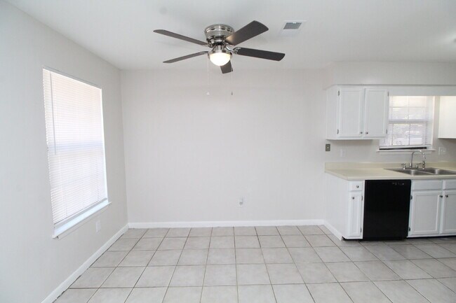 Building Photo - 1BR Townhome with Private Fenced Backyard & Tile Flooring Throughout