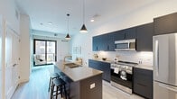 This 520 square foot apartment in Saint Paul, MN, offers a thoughtfully designed living space that maximizes functionality and style. The single-floor layout encompasses one bedroom, one bathroom, a kitchen, and a closet, creating an efficient and comfortable living environment.

The kitchen is a standout feature, boasting sleek dark cabinetry contrasted with white subway tile backsplash and stainless steel appliances. A central island with seating provides additional counter space and a casual dining area. Modern pendant lighting enhances the contemporary aesthetic.

The bathroom showcases a clean, minimalist design with a white vanity, ample storage, and a large mirror. Light-colored flooring throughout the apartment creates a sense of spaciousness and brightness.

The bedroom, measuring 100 square feet, features a large window that floods the space with natural light. It includes a walk-in closet for added storage and organization. The room is adorned with neutral tones and simple, elegant decor.

Throughout the apartment, the color palette is predominantly white and gray, creating a modern and cohesive look. The light wood-look flooring adds warmth to the space. High ceilings and recessed lighting contribute to the open and airy feel of the apartment.

This well-designed urban dwelling efficiently utilizes its 520 square feet to provide a comfortable and stylish living space, perfect for those seeking a modern apartment in the heart of Saint Paul.