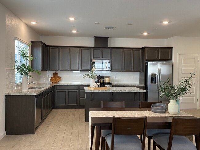 Modern kitchen with large island and stainless steel appliances - 1683 Sandoval Dr