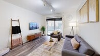 Located at 901 Mountcastle St in Knoxville, TN, this thoughtfully designed three-bedroom, three-bathroom residence offers a well-organized single-floor layout. The open-concept kitchen and living area serves as the heart of the home, where a modern kitchen features stainless steel appliances—including a full-size refrigerator, range, microwave, and dishwasher—complemented by two-tone cabinetry in white and warm wood tones, light quartz countertops, and a peninsula with bar seating. The adjacent living room is bright and welcoming, with track lighting overhead and a large sliding glass door that opens to a private balcony. Wood-style flooring runs throughout the main living areas, adding warmth and continuity. Each of the three bedrooms is well-proportioned, with the primary bedroom offering generous closet space. Bedrooms feature tall ceilings and large windows that bring in natural light. The three bathrooms are cleanly finished, with one featuring a glass-enclosed walk-in shower and another a full soaking tub. Additional conveniences include a dedicated laundry area, utility room, hallway, and four closets for ample storage throughout.