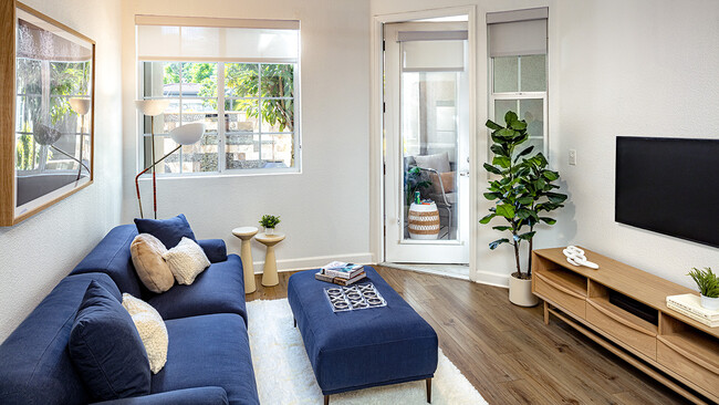 Apartment living room with wood-style flooring. - Griffis South Bay