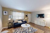 Located at 2788 Defoors Ferry Rd NW in Atlanta, GA, this two-story, 2-bedroom, 1-bathroom home is thoughtfully laid out across two well-proportioned floors. The main level opens into a welcoming living room finished with hardwood-style flooring, neutral walls, and natural light streaming through multiple windows. The space flows into a combined dining area and kitchen, where a large sliding glass door provides direct outdoor access and fills the room with abundant natural light and greenery views. The kitchen features white shaker cabinetry, dark stone countertops, a subway tile backsplash, and stainless steel appliances, including a bottom-freezer refrigerator. A dedicated laundry area with a top-load washer and tankless water heater adds everyday convenience. Upstairs, the generously sized primary bedroom is distinguished by a warm terracotta accent wall, a ceiling fan, and a natural window view. The second bedroom offers plush carpeting, a ceiling fan, and a sliding-door closet. The full bathroom includes a tiled tub/shower combo with a window for natural ventilation. With four closets throughout, this home offers ample storage to complement its practical and comfortable layout.
