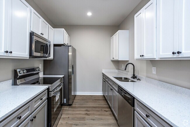 Experimente la elegancia de este moderno diseño de cocina, perfecto para aventuras culinarias. - Woodford Ridge Townhomes