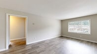 Located at 1940 Flat Shoals Rd SE in Atlanta, GA, this single-story, one-bedroom, two-bathroom home offers a thoughtfully designed layout with modern finishes throughout. The open-concept living and dining area is finished with wood-style plank flooring and neutral-toned walls, creating a bright and welcoming atmosphere. Natural light flows in through well-placed windows, lending warmth to the space.

The kitchen is a functional highlight, featuring rich wood cabinetry, dark granite countertops, a double basin sink, and a full suite of black appliances including a refrigerator, range, dishwasher, and built-in microwave. The wood-style flooring continues here, maintaining a cohesive look throughout the common areas.

The spacious primary bedroom is carpeted for comfort and benefits from a large window with neighborhood views. Two closets provide ample storage throughout the home. Both bathrooms are well-appointed, with granite vanity tops, wood cabinetry, and hardwood-style tile flooring. One bathroom includes a full soaking tub with a window above for natural light.

A connecting hallway ties the rooms together efficiently, completing this well-organized and move-in-ready home.