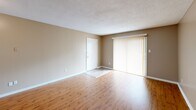 Located at 3610 Spottswood Ave in Memphis, Tennessee, this single-story, 2-bedroom, 3-bathroom home offers a practical and well-organized layout with consistent warm neutral tones throughout. The living room features wood-look hard flooring and a large sliding glass door fitted with vertical blinds, allowing natural light to fill the space. The kitchen is well-equipped with white cabinetry, ample counter space, a stainless steel sink, white appliances including a refrigerator, range, and dishwasher, and light wood-look flooring that complements the living area. Both bedrooms are carpeted and bathed in warm neutral tones, with windows providing natural light and access to dedicated closets. The spacious primary bedroom offers generous room dimensions and a connected closet. Three bathrooms serve the home — one features a full tub/shower combo with built-in shelving, while another offers a vanity with white cabinetry and a lighted mirror. A hallway connects the main living areas to the private quarters. Textured ceilings are found throughout, adding a classic residential character to the home.