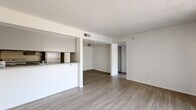 Located at 4102 W Osborn Rd in Phoenix, Arizona, this one-bedroom, one-bathroom unit offers a practical and well-organized single-floor layout. The open living and dining area is bright and airy, featuring light wood-look flooring and a textured ceiling throughout. Large vertical-blind-covered sliding doors allow natural light to pour into the living space, creating a clean, welcoming atmosphere with a neutral white color palette.

The kitchen is laid out in a galley style, featuring gray upper and lower cabinetry, speckled gray countertops, a double-basin stainless steel sink, and a white electric range. A pass-through window connects the kitchen to the living area, enhancing the sense of openness.

The bedroom is a comfortable, well-proportioned room with the same light wood-look flooring, a window with natural light, and a textured ceiling. It provides a calm, minimalist retreat.

The bathroom includes a full tub and shower combination with a chrome curtain rod, a toilet, and a vanity with a speckled countertop, finished with dark wood-look flooring. A dedicated utility room adds practical storage and functionality. This unit offers a straightforward, move-in-ready layout suited for everyday living in the heart of Phoenix.