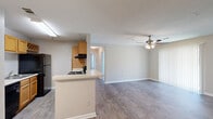 Located at 4801 Baker Grove Rd NW in Acworth, Georgia, this single-story home features four bedrooms, two bathrooms, and a practical, well-organized layout. The open-concept kitchen and living area serves as the heart of the home, highlighted by wood-look flooring, a ceiling fan with light fixture, and vertical blinds that allow for natural light. The kitchen is galley-style, equipped with warm honey-toned wood cabinetry, black appliances including a refrigerator, electric range, and dishwasher, a built-in range hood, and a double-basin sink with ample counter space. A peninsula counter connects the kitchen to the living and dining areas, creating a seamless flow. The dining room features a multi-bulb chandelier and the same durable flooring found throughout the main living spaces. The bedrooms offer a comfortable scale, with some featuring plush carpeting, built-in closets with shelving, and windows with blinds that bring in natural light. The primary bedroom includes sliding door access. Both bathrooms are functional and clean, one featuring an angled vanity with warm wood cabinetry, a lighted mirror, and a separate shower, while the other includes a full soaking tub with shower combination. A hallway connects the bedrooms efficiently, completing this well-appointed home.