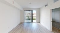 This contemporary 880 square foot apartment offers a harmonious blend of functionality and style. The open-concept living area seamlessly integrates the kitchen and living room, creating a spacious feel. The kitchen boasts sleek white cabinetry, stainless steel appliances, and a central island, perfect for meal preparation and casual dining.

Light wood-look flooring runs throughout, complementing the crisp white walls and enhancing the bright, airy ambiance. Large windows in the living area and bedrooms allow natural light to flood the space, with some offering picturesque views of palm trees, suggesting a pleasant outdoor environment.

The primary bedroom, measuring 160 square feet, provides ample space for relaxation. Two additional bedrooms offer versatility for various living arrangements. The bathrooms feature modern fixtures, with at least one showcasing a stylish walk-in shower with large format tiles.

Thoughtful design elements include track lighting in the kitchen, pendant lights, and built-in closets for optimal storage. A small balcony accessible from the living area extends the living space outdoors.

This single-story apartment combines contemporary design with practical living, making it an ideal home for those seeking a modern urban lifestyle.