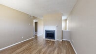 Located at 110 E Hawkins Pkwy in Longview, Texas, this single-story, 2-bedroom, 2-bathroom home offers a practical and comfortable layout. The living room serves as the heart of the space, highlighted by a classic white-mantled fireplace and warm wood-look flooring that extends throughout the main living areas. Natural light filters in through slatted blinds, lending the space a bright and welcoming feel. A half-wall partition adds a subtle architectural detail that defines the living area from adjacent spaces.

The kitchen features warm wood cabinetry, a window above the sink, and black appliances including a refrigerator and dishwasher. A dedicated pantry provides additional storage, while the in-unit laundry adds everyday convenience.

Both bedrooms are carpeted and finished in neutral warm tones, offering a cozy retreat. The primary bedroom is generously sized and includes a closet with bi-fold doors, while a window provides natural light. The second bedroom is equally comfortable with its own closet. Two full bathrooms serve the home, one featuring a tiled tub-shower combination.

A central hallway connects the rooms efficiently throughout the single-floor layout. Textured ceilings are consistent throughout, and the neutral color palette creates a cohesive, move-in-ready aesthetic throughout the entire home.