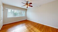 This 520-square-foot apartment in Saint Petersburg, FL, offers a surprisingly spacious feel despite its compact size. The single-floor layout features three bedrooms, including a primary bedroom of 180 square feet, providing ample living space. Throughout the apartment, gleaming hardwood floors create a warm, inviting atmosphere and contribute to the overall brightness of the rooms.

Large windows in each bedroom allow natural light to flood the space, while also offering views of the surrounding area, including glimpses of palm trees. Ceiling fans in the bedrooms provide both illumination and air circulation, enhancing comfort. The kitchen, though compact, is efficiently designed with white cabinetry, a tiled countertop with a distinctive pink border, and essential appliances.

The bathroom showcases a classic design with beige tiled walls accented by a black border, a standard bathtub-shower combination, and a window for natural ventilation. Built-in closets in the bedrooms offer valuable storage space, maximizing the utility of the compact floor plan.

Located at 301 Fourth Ave N in Saint Petersburg, this apartment combines urban convenience with a cozy, well-designed living space, making it an attractive option for those seeking a comfortable home in a prime location.