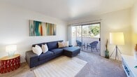 Located at 7826 Center Pkwy in Sacramento, CA, this single-story residence offers two bedrooms and three bathrooms within a well-designed, efficiently laid-out floor plan. The combined kitchen and living room serves as the heart of the home, with the living area featuring plush carpeting, neutral walls, and a sliding glass door that opens to a private outdoor patio with outdoor seating and pleasant green views. The kitchen is outfitted with gray cabinetry, light stone-look countertops, wood-style flooring, and black appliances including a range, dishwasher, and refrigerator — providing a functional and modern workspace. A dedicated dining area adjoins the kitchen seamlessly. The primary bedroom is a comfortable retreat, featuring carpet flooring, a window with outdoor views, and ample wall space. The second bedroom is bright and versatile, also carpeted and equipped with a closet. All three bathrooms are clean and functional, with at least one featuring a full soaking tub with shower combo, white surround, wood-style flooring, and a granite-style vanity countertop with a large mirror. The overall aesthetic is clean and contemporary, with a consistent neutral color palette throughout.