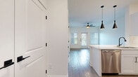 Located at 14818 Vintage Preserve Pkwy in Houston, TX, this thoughtfully designed one-bedroom, one-bathroom residence offers a clean, modern aesthetic across a single floor. The open-concept layout seamlessly connects the kitchen and living room, creating an efficient and welcoming flow throughout the space. Light wood-tone flooring runs throughout, complementing the bright white walls and trim that give the home an airy, contemporary feel.

The kitchen is a standout feature, boasting white shaker-style cabinetry with matte black hardware, quartz countertops, a peninsula with an undermount sink, and a full suite of stainless steel appliances including a refrigerator, range, microwave, and dishwasher. Striking black cone pendant lights add a modern touch overhead. The living area benefits from natural light streaming through multiple windows fitted with horizontal blinds, and a ceiling fan overhead provides added comfort.

The spacious primary bedroom features light hardwood floors, a ceiling fan, and a window with outdoor views. Three closets provide generous storage throughout the unit. The bathroom is well-appointed with a white vanity, quartz countertop, matte black fixtures, a soaking tub with tile surround, and built-in shelving. A dedicated laundry area completes this efficiently organized home.
