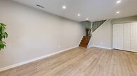 Located at 50 Knollwood Drive in Lancaster, PA, this two-story home offers a thoughtfully designed layout spread evenly across two floors. The main level welcomes you with a bright entry area featuring light wood-style flooring, recessed lighting, and neutral walls that carry throughout the home. The open living room provides a comfortable gathering space anchored by a staircase with a stylish metal railing leading to the upper floor. The kitchen is a standout, equipped with white shaker-style cabinetry, granite countertops, stainless steel appliances including a gas range and built-in microwave, and a deep sink — all complemented by the same light hardwood flooring. A utility room with in-unit laundry is conveniently accessible from the kitchen. Upstairs, two bedrooms offer restful retreats, each with plush carpeting and windows that invite natural light. The primary bedroom features a ceiling fan for added comfort. The full bathroom is elegantly finished with tile flooring, large-format tile surround in the tub/shower combination, dual white vanities with granite countertops, and clean, modern hardware. Hallways on both floors connect the spaces efficiently, completing this move-in-ready home.
