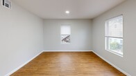 Located at 28-38 North St in Ware, Massachusetts, this one-bedroom, one-bathroom unit offers a practical and efficient layout across a single floor. The space is finished with warm-toned hardwood-style flooring throughout, complemented by clean, light gray walls and crisp white trim that create a bright, neutral aesthetic.

The living room serves as the main gathering area, featuring a recessed entry door and windows fitted with blinds that allow for natural light while maintaining privacy. The kitchen is equipped with stainless steel appliances, including a full-size refrigerator, and is accessible directly from the living area, making the layout functional and open.

The bedroom offers a comfortable, cozy footprint with a window overlooking the outdoors, a closet with bifold doors, and recessed lighting overhead. A hallway connects the primary spaces, providing a clear and organized flow through the unit.

The bathroom features a full-size tub and shower combo with a clean, molded surround. Throughout the unit, recessed lighting supplements the natural light from multiple windows, keeping the interior well-lit. The consistent flooring, neutral palette, and clean finishes give the space a cohesive, move-in-ready appearance well-suited for comfortable single-occupant living.