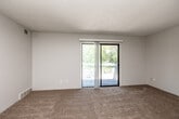 Located at 3700 Twana Dr in Des Moines, Iowa, this 2-bedroom, 1-bathroom unit offers a practical and well-organized single-floor layout. The open-concept kitchen and living area forms the heart of the home, with the kitchen featuring white cabinetry, a black electric range, a white refrigerator, a stainless sink with light countertops, and wood-look vinyl flooring that adds a clean, modern touch. A ceiling fan with light fixture provides both comfort and illumination. The living room flows naturally from the kitchen, transitioning to plush neutral carpet and offering access to a private balcony through a sliding glass door with vertical blinds, letting in natural light and outdoor views of surrounding greenery. Both bedrooms are carpeted and feature windows with blinds that bring in soft, natural light, creating calm and functional spaces. Two closets throughout the unit provide convenient storage. The shared full bathroom includes a vanity with a light countertop, a large mirror, and under-sink cabinet storage. Textured ceilings are consistent throughout, and a connecting hallway ties the rooms together with ease. This unit delivers a straightforward, functional layout well-suited for comfortable everyday living.