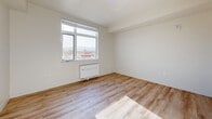Located on the third floor at 3100 S Bascom Ave in San Jose, California, this one-bedroom, one-bathroom unit offers a clean, modern design with a thoughtful layout. Light wood-style flooring flows throughout the main living areas and bedroom, lending a warm, cohesive feel to the space.

The bedroom is generously proportioned and features a large window that fills the room with natural light while framing scenic mountain and neighborhood views. A wall-mounted HVAC unit provides convenient climate control directly in the room.

The kitchen is efficiently designed with light gray cabinetry, recessed lighting, and a full suite of appliances including a stainless steel refrigerator and a gas range. The kitchen connects seamlessly to the main living area, which also includes a closet with built-in shelving and a louvered-door storage area.

The bathroom is spacious and accessibility-conscious, featuring multiple grab bars, a white vanity with a clean-lined countertop, a mirror, and neutral tile flooring. The bright white walls throughout the unit contribute to an open, airy ambiance.

Overall, the unit presents a minimalist aesthetic with practical finishes, abundant natural light, and a well-organized floor plan suited for comfortable everyday living.