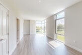 Located in McLean, VA, this modern 2-bedroom, 1-bathroom residence offers a well-designed open-concept layout with contemporary finishes throughout. The combined kitchen and living area serves as the heart of the home, centered around a sleek island with a white quartz countertop, an integrated sink, and stylish pendant lighting above. Dark wood cabinetry contrasts beautifully with light wood-style flooring, and stainless steel appliances—including a refrigerator, microwave, and range—complete the functional kitchen. The living area is bathed in natural light through expansive floor-to-ceiling windows that frame lush green outdoor views and the surrounding McLean skyline. Both bedrooms feature plush carpeting and large windows that continue the home's bright, airy aesthetic. The primary bedroom connects directly to the full bathroom, which is finished with large-format tile flooring, a tiled tub-shower combination, and a modern vanity with blue-toned cabinetry and a light countertop. A dedicated closet provides additional storage. Neutral tones, clean lines, and abundant natural light create a cohesive, contemporary ambiance throughout this well-appointed McLean residence.