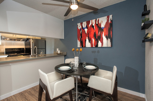 View Of Dining Room With Blue Accent Wall With Decor - Artisan Square