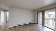 Located at 142 S Maplewood St in Greenville, Michigan, this one-bedroom, one-bathroom unit offers a well-organized, single-floor layout designed for comfortable everyday living. Warm-toned luxury vinyl plank flooring runs consistently throughout, lending a clean, cohesive look to every room.

The living room is a bright, open space anchored by a sliding glass door that opens to a private balcony with outdoor views. Vertical blinds provide adjustable light control, and a baseboard heating system runs along the wall, ensuring year-round comfort.

The kitchen is efficiently laid out with warm oak cabinetry, granite-style countertops, and stainless steel appliances including a dishwasher and refrigerator. It connects seamlessly to the main living area, making the space feel open and functional.

The bedroom is a well-proportioned room featuring a closet with bi-fold doors and a window dressed with vertical blinds that allow natural light to filter in. A baseboard heater ensures the room stays comfortable throughout the seasons.

The bathroom is clean and practical, featuring an oak vanity with a single sink, stone-look countertop, a well-lit mirror, and a full tub-shower combination. Light flooring ties the space together with the rest of the unit. This unit offers a straightforward, move-in-ready layout in a convenient Greenville location.