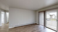 Located at 142 S Maplewood St in Greenville, Michigan, this one-bedroom, one-bathroom unit offers a well-organized, single-floor layout designed for comfortable everyday living. Warm-toned luxury vinyl plank flooring runs consistently throughout, lending a clean, cohesive look to every room.

The living room is a bright, open space anchored by a sliding glass door that opens to a private balcony with outdoor views. Vertical blinds provide adjustable light control, and a baseboard heating system runs along the wall, ensuring year-round comfort.

The kitchen is efficiently laid out with warm oak cabinetry, granite-style countertops, and stainless steel appliances including a dishwasher and refrigerator. It connects seamlessly to the main living area, making the space feel open and functional.

The bedroom is a well-proportioned room featuring a closet with bi-fold doors and a window dressed with vertical blinds that allow natural light to filter in. A baseboard heater ensures the room stays comfortable throughout the seasons.

The bathroom is clean and practical, featuring an oak vanity with a single sink, stone-look countertop, a well-lit mirror, and a full tub-shower combination. Light flooring ties the space together with the rest of the unit. This unit offers a straightforward, move-in-ready layout in a convenient Greenville location.