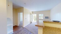 Located at 1035 South Main Street in Decatur, Illinois, this well-laid-out 2-bedroom, 1-bathroom residence offers a comfortable and functional single-floor living experience. The open-concept living and dining area is bathed in natural light from large windows and a sliding glass door that leads to a private balcony, offering pleasant outdoor views. The transition from durable wood-style flooring in the entryway and kitchen to plush carpet in the living and bedroom areas adds warmth and distinction throughout the space.

The galley-style kitchen features warm wood cabinetry, granite-look countertops, a stainless steel sink, and white appliances, including a refrigerator and electric range. An entryway area includes built-in open shelving, providing practical storage from the moment you step inside.

Both bedrooms are carpeted and include ceiling fans with light fixtures, windows with natural light, and baseboard heating. The spacious primary bedroom offers generous proportions and connects to a large walk-in closet with wire shelving. A second well-sized closet serves the additional bedroom. The full bathroom is outfitted with a tub-shower combo and accessibility grab bars, finished with wood-style flooring. The unit also includes a ceiling fan in the entry area, adding to overall comfort throughout.