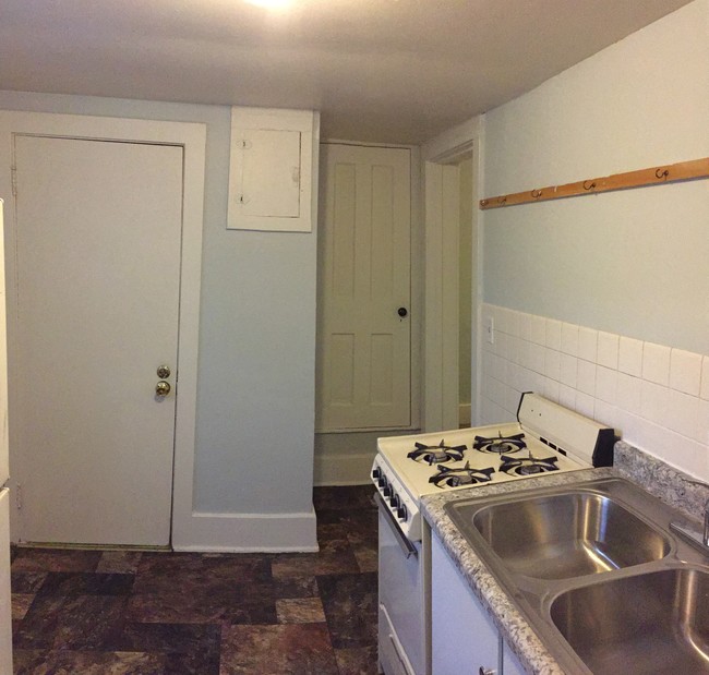 Kitchen w/ Stove and Refrigerator - 1411 Portland Ave